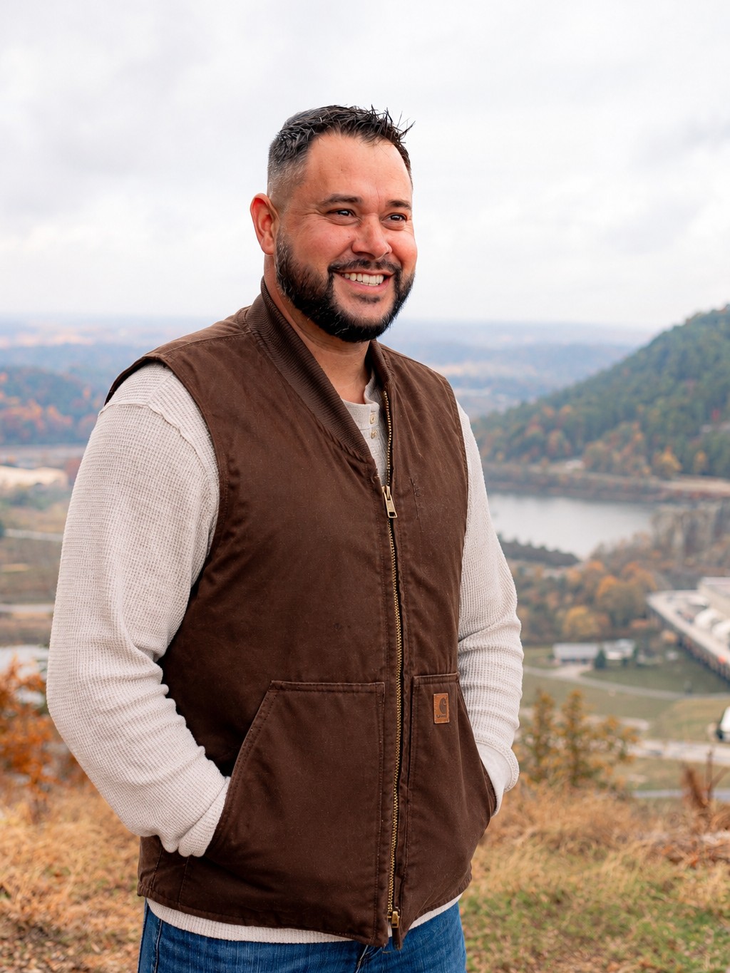 Bryan Phillips, who runs Pickens Pools, standing on a hillside overlooking the valley